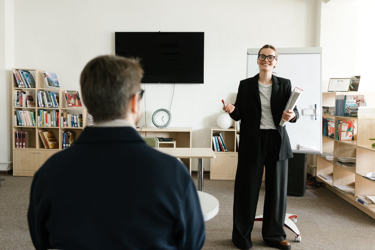 creative Businesswoman giving presentation in office with bookshelves and clock.
